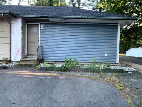 Entry door of 10 George Avenue after re-siding with mail slot and exterior light