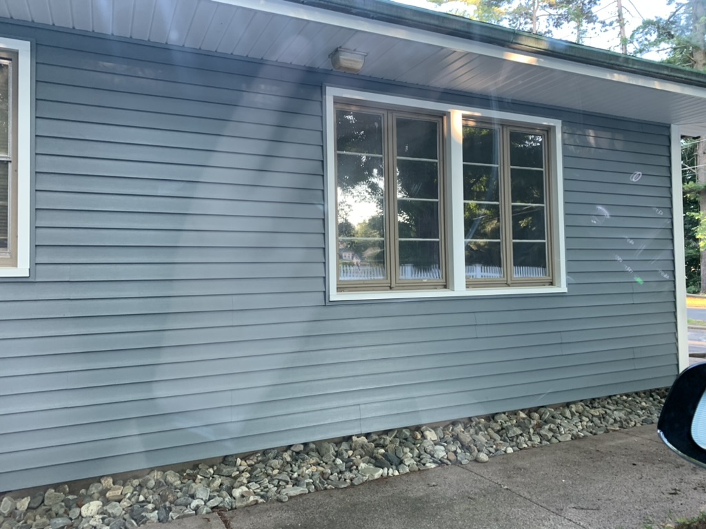 Large window of 10 George Avenue with new white trim after re-siding