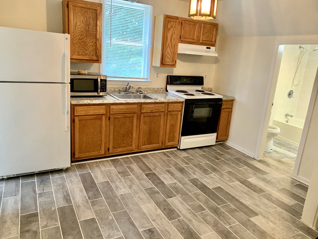 Finished kitchen with oak cabinets, granite counters, and stainless sink at 36 Pratt Street