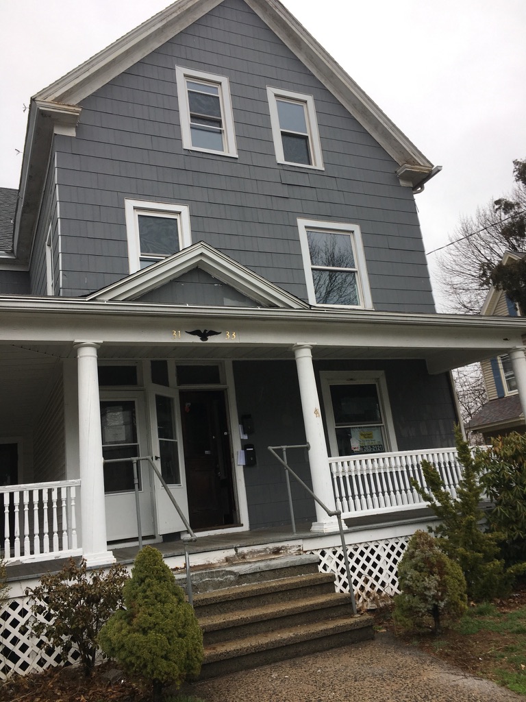 31 Wallace Street exterior during renovation with porch framing exposed
